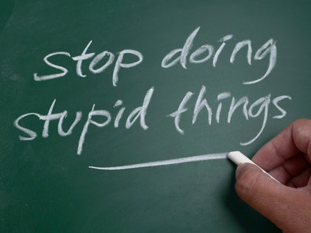 Stop doing stupid things, word text written on chalkboard, motivational inspirational life quotes conceptの写真素材