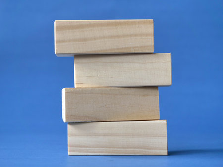 Empty blank wooden block stacked on blue background, text templateの写真素材