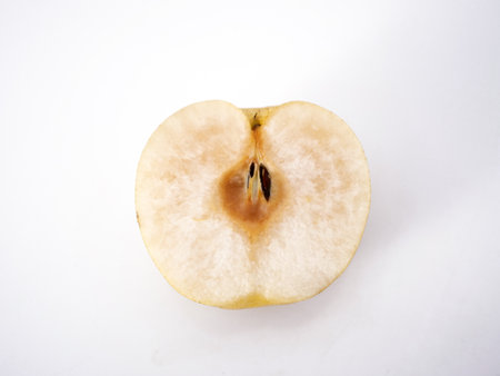 Fresh pear fruit; half sliced on whiteの写真素材