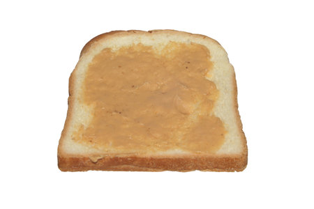 Slice of toast with peanut butter on it, cut out isolated on white