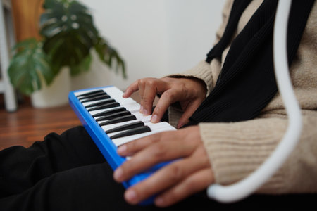 Anonymous woman playing pianica, melodica blow musical instrumentの写真素材
