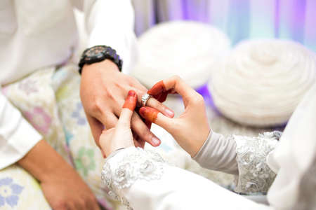Female and male hand, image of mehendi henna pattern. Short manicure nails. Beautiful composition, fabric background banner. Round mandala abstract flowers, flowers lilac. Close up professional art photoの写真素材