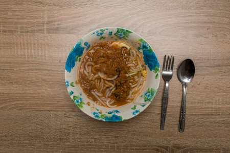 Noodles in bowl on the wooden table.visible noise due to high iso.の写真素材