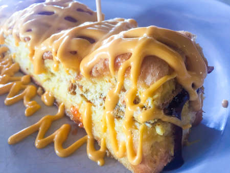 bread with cheezy sauce on white plate. visible noise due to high ISO