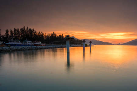 Beautiful view of sunset at Lumut,Perak,Malaysia. soft focus, blur due to long exposure. Visible noise due to high ISO.の写真素材