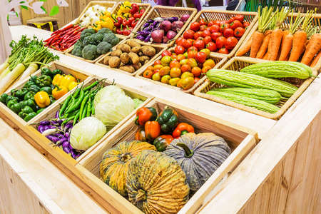 Organic vegetables in a basket on Shelfの写真素材