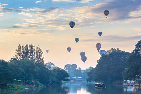 CHIANG MAI, THAILAND - DEC 06 : Balloon floating to sky during Thailand international balloon festival 2014 with foreground ping river in the morning on Dec 06, 2014 in Chiangmai, Thailand.のeditorial素材