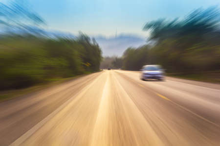 Motion blur of a rural road to infinity from inside a moving carの写真素材