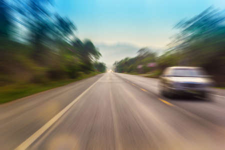 Motion blur of a rural road to infinity from inside a moving carの写真素材