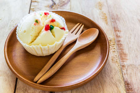 Close up shot Steamed Cup Cake in wood dish on wood tableの写真素材