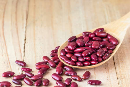 Close up shot Red beans in a ladle on wood tableの写真素材