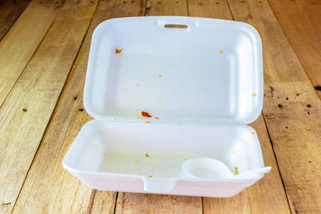 Garbage in Foam used on wood tableの写真素材