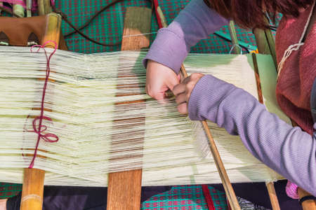 Close up shot Hands of a woman was weaving, Selective focus on hand