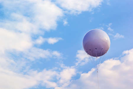 A photo of white balloon on blue sky background