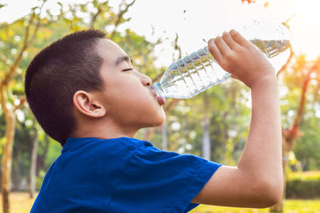 A photo of a Boy drinking water from bottleの写真素材