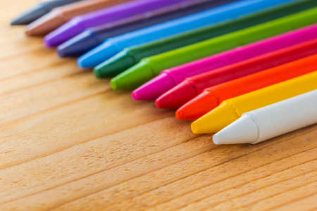 A photo of colorful crayon color on wood texture, Selective focusの写真素材