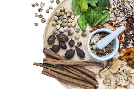 A photo of Herbal medicine in wood dish on white isolate background with space for textの写真素材