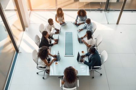 High angle shot of a diverse business team discussing business in a conference room. Principles of diversity and inclusiveness in business. Top viewの素材