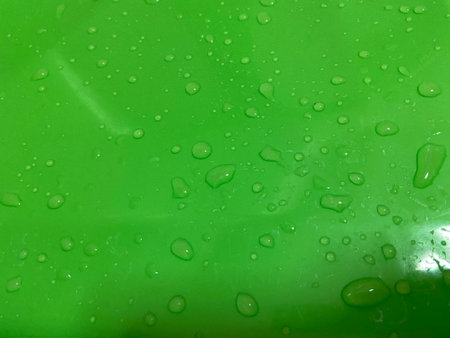 Water drops on green plastic background. Water drops on green plastic.の写真素材