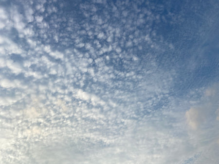 The vast blue sky and clouds on a sunny day.の写真素材