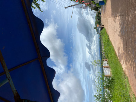 Blue sky and white clouds reflected in water of a river. Natural background.の写真素材