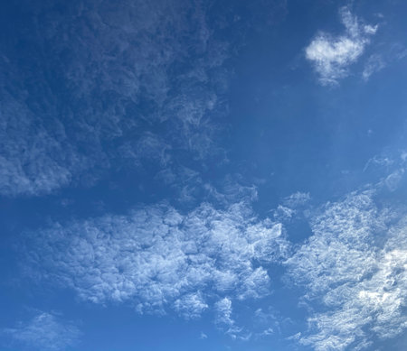 Blue sky background with tiny clouds. Nature background. Blue sky with tiny clouds.の写真素材