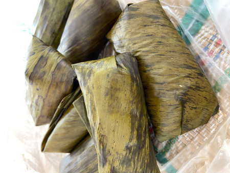 Thai dessert made from glutinous rice wrapped in banana leaf.の写真素材