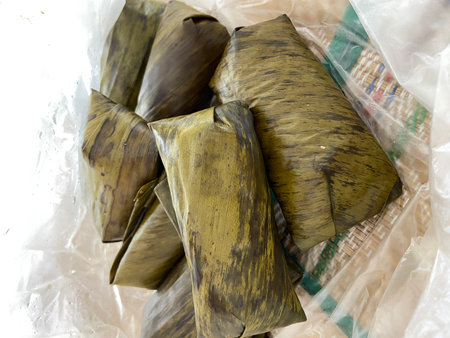 Thai dessert made from glutinous rice wrapped in banana leaves.の写真素材