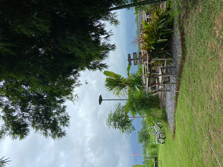 Bungalows in the green grass and blue sky with cloudsの写真素材