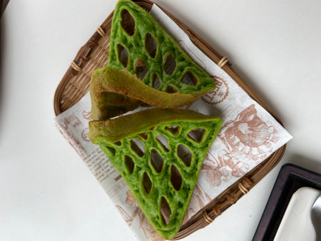 Thai dessert made of green lotus leaf on white background.の写真素材
