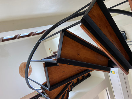 wooden spiral staircase in a modern house, closeup of photoの写真素材