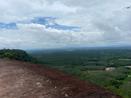 View from the top of the mountain to the forest and the skyの写真素材