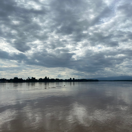 Beautiful landscape of the river and cloudy sky at sunset time.の写真素材