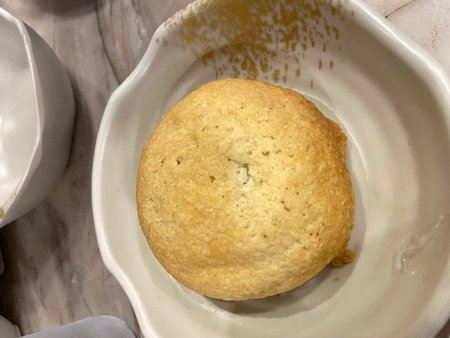 Close-up of a round bread in a white plate on a table