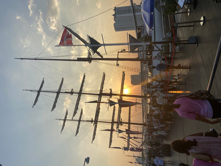 Silhouette of a sailing ship in the sunset light with sun rays