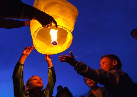 Children are seen launching a paper lantern during the manifestations on the International Children's Day, in Galati, Romania, June 1, 2013.のeditorial素材