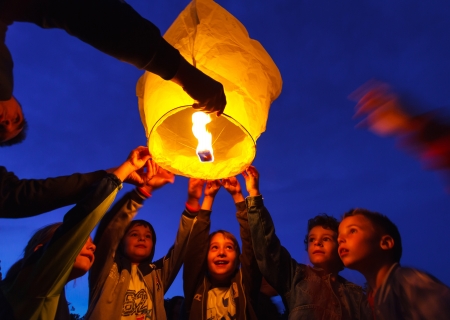 Children are seen launching a paper lantern during the manifestations on the International Children's Day, in Galati, Romania, June 1, 2013.のeditorial素材