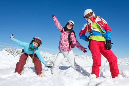 Long live family ski holidays and mountain vacations. A group of children on winter sport vacation playing in the snow on the ski slopes in the Alps, Franceの写真素材