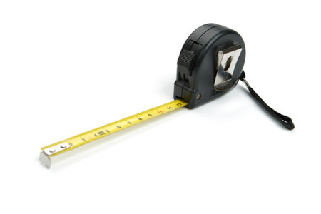 Black tape measure unrolled or measuring tape, cut out and isolated on white backgroundの写真素材