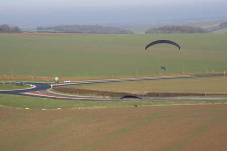 Aerial photograph of a paramotor (motorized paraglider) flying over a roundabout in soindres fields, Yvelines department (78200), Ile-de-France region, France - January 03, 2010の写真素材