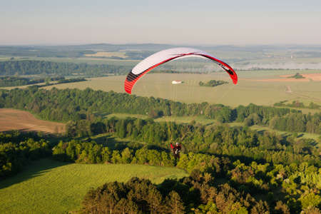 In morning, one paramotor flying over the fields in Yonne department, in Bourgogne-Franche-ComtÃ© region, Franceのeditorial素材