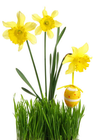 concept of spring season and french easter holidays: Green grass with bouquet of flowers and hanging Easter egg cut out and isolated on white backgroundの写真素材