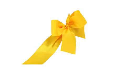 Decorative yellow ribbon and bow cut out and isolated on white backgroundの写真素材