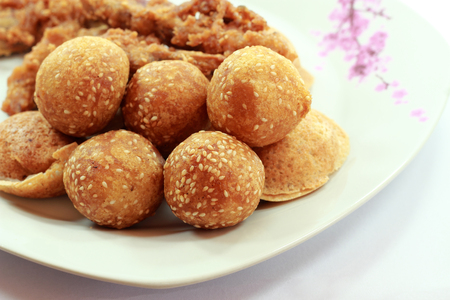 Golden cheese balls fried  covered with sesame on a plate の写真素材
