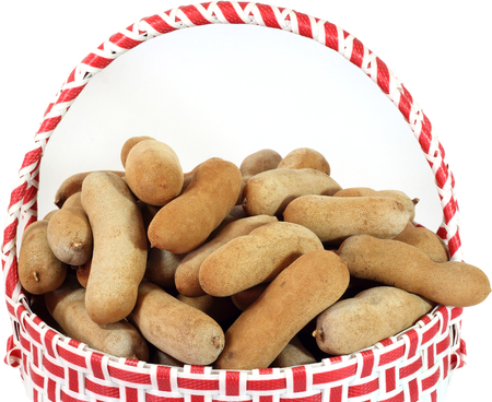 Tamarind in  plastic basket  on white  の写真素材