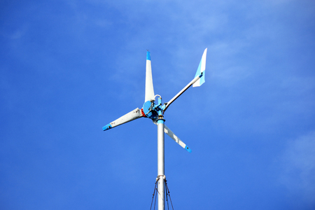 Wind energy turbine on blue sky の写真素材
