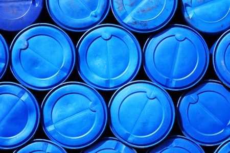 Blue plastic barrels containing chemicals on storage の写真素材