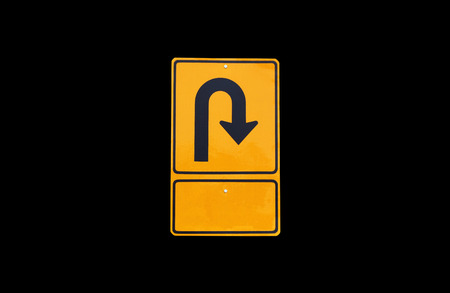 Turn back traffic sign on  black  background の写真素材
