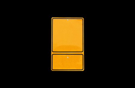 empty yellow traffic road sign on black backgroundの写真素材