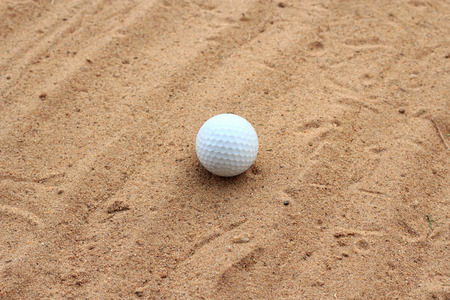 Golf ball  on sand の写真素材